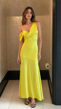 Front view of woman wearing yellow asymmetric draped satin maxi dress