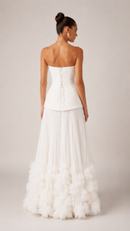Back view of ivory strapless maxi gown with lace-up back and textured ruffle hem