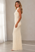 Side view of ivory mock neck textured mermaid maxi dress