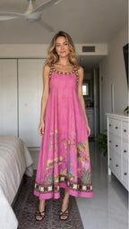 Woman wearing pink boho floral embroidered maxi dress, front view