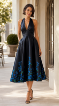 Front view of black halter midi dress with blue floral hem print
