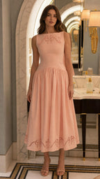 Front view of model wearing peach embroidered midi dress