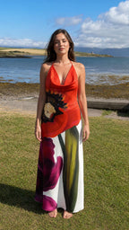 Front view of red floral halter maxi dress by the coast