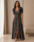 Front view of black printed puff sleeve V-neck maxi dress with front slit