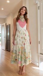 Front view of model wearing white floral midi dress with fringe accent