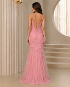 Back view of blush pink floral appliqué mermaid maxi dress with lace-up open back