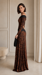 Side view of brown long-sleeve off-shoulder floor-length gown with fitted silhouette