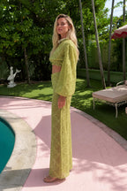 Side view of model wearing olive two-piece set outdoors