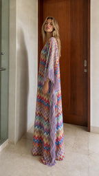 Side view of model in multi-colored chevron fringe maxi kaftan dress
