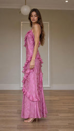 Side profile view of pink ruffled maxi dress