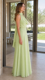 Side profile view of sage green halter maxi dress