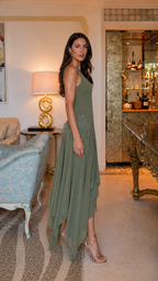 Side view of olive flowy maxi dress with asymmetrical hem and fitted bodice