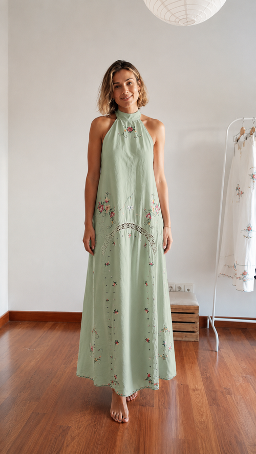 Front view of sage embroidered halter maxi dress with flowing silhouette