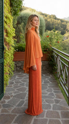 Side view of orange cape overlay maxi dress