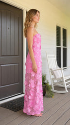 Side view of model wearing pink 3D floral strapless maxi dress