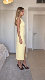 Side profile view of yellow midi dress on model