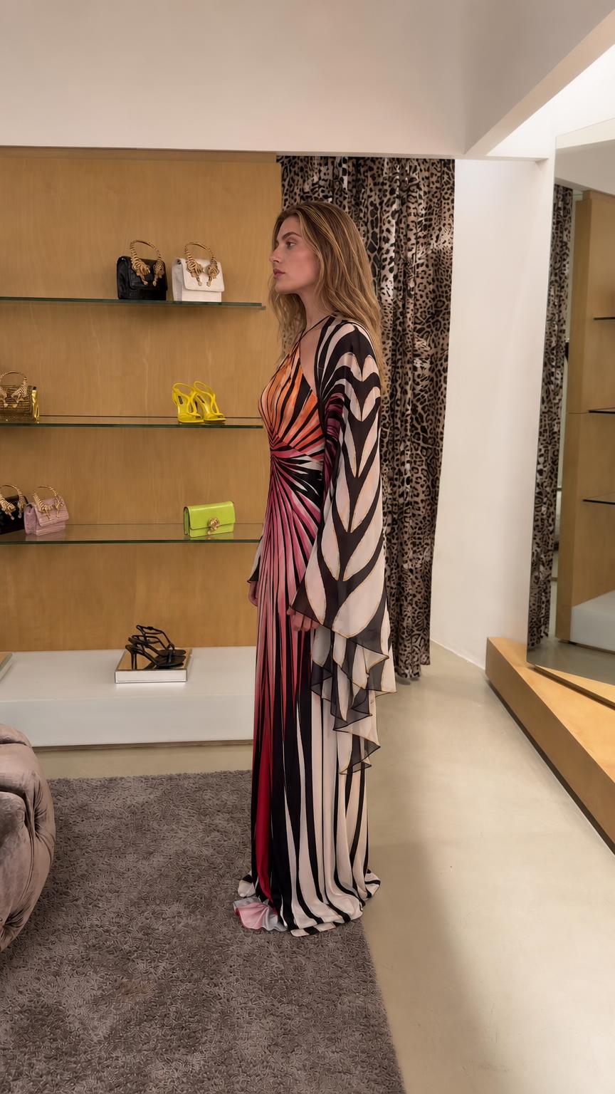 Side profile view of sunset pink maxi dress