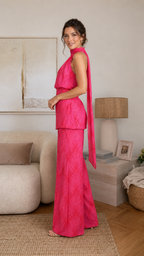 Side view of hot pink sleeveless halter two-piece wide-leg pants set