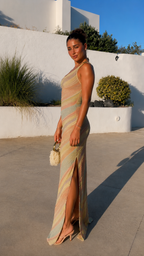 Side angle of pastel striped one-shoulder fitted maxi dress with high slit