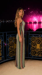 Side profile of model in multi-colored sequin maxi dress