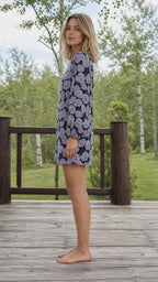 Side profile view of woman in navy floral shift dress