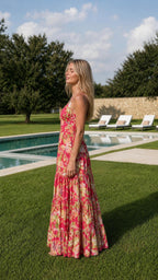 Side profile view of fuchsia floral tiered maxi dress