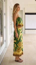 Side profile view of model wearing the yellow tropical two-piece skirt set