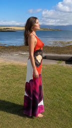 Side profile of red floral halter maxi dress