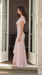 Side profile of woman in pink floral maxi dress