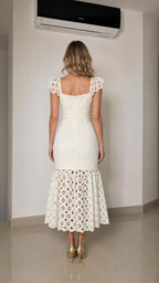 Back view of woman wearing white lace dress