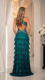 Back view of teal formal gown with open back and crossover strap detail