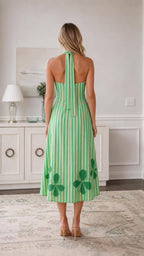 Back view of green striped midi dress showing halter ties