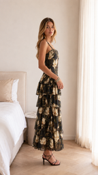 Side view of black floral one-shoulder tiered maxi dress