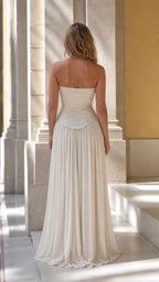 Model wearing Champagne corset pleated maxi dress back view