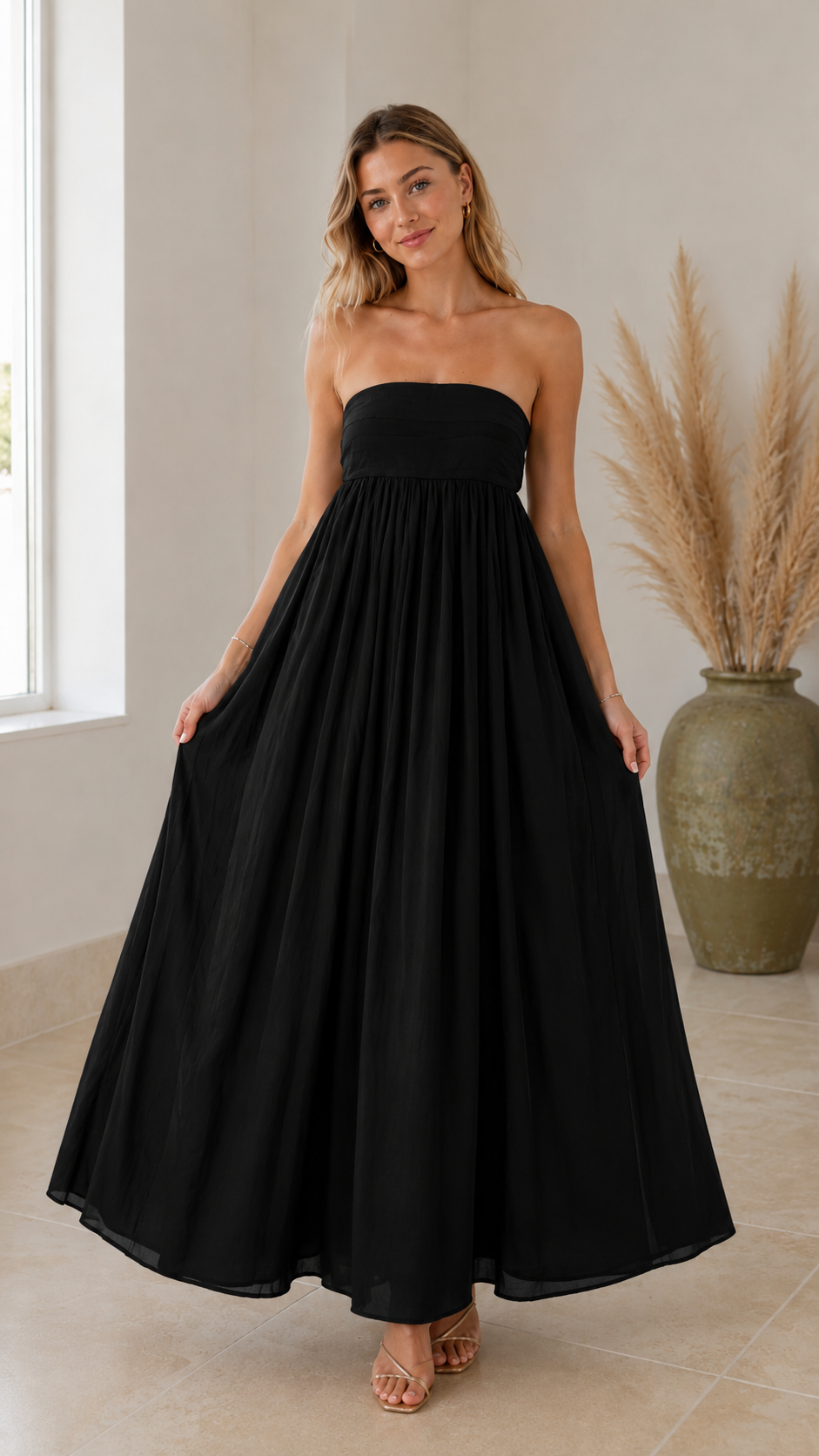 Front view of black strapless maxi dress with smocked-looking bodice and A-line silhouette