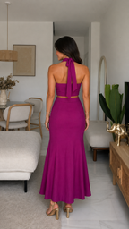 Back view of fuchsia open-back halter top and flared maxi skirt set