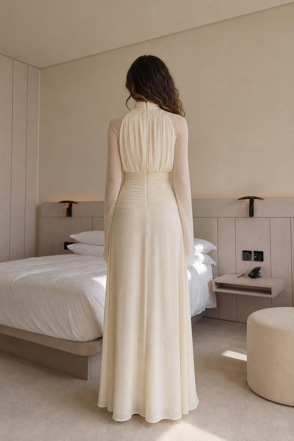 Back view of woman wearing cream pleated maxi dress