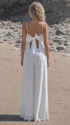 Back view of woman showing tie-back detail on white tank top
