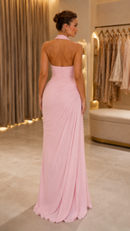 Back view of blush pink halter maxi dress with open back and floor-length drape