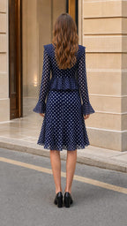 Back view of model wearing Navy polka dot midi dress