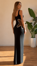 Back view of black maxi dress showing side cutout placement and slim fit silhouette