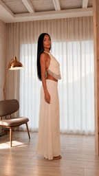 Side view of champagne halter crop top and long embellished skirt set