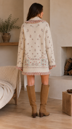Back view of cream floral knit cardigan jacket with border detail and fringe hem