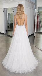 Back view showing open back of white tulle ball gown