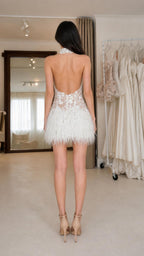 Back view showing open back design of white lace mini dress
