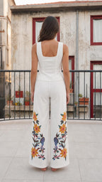 Back view of woman wearing white embroidered matching set