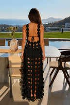 Back view showcasing back tie closure on black statement dress
