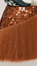 Close-up of brown sequin and fringe skirt detail
