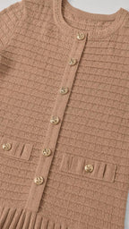 Close-up detail of knit texture and gold buttons