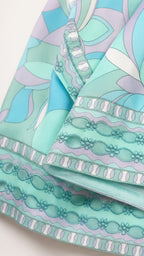 Close-up detail of fabric pattern and embroidered hem
